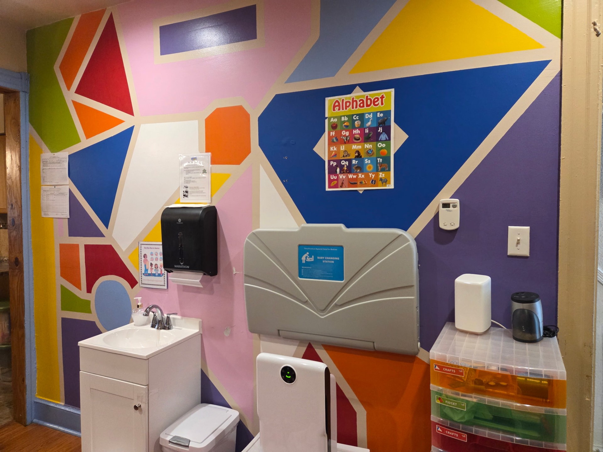 Alphabet posters above our tidy changing station.